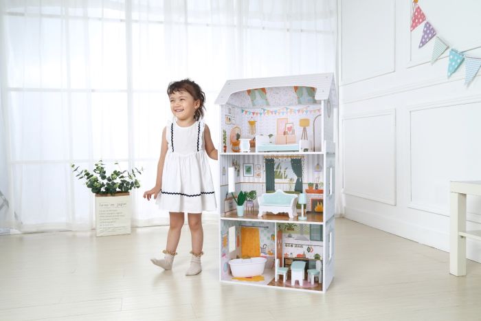 Child playing with Wooden Dollhouse Luna with LED lights, arranging furniture