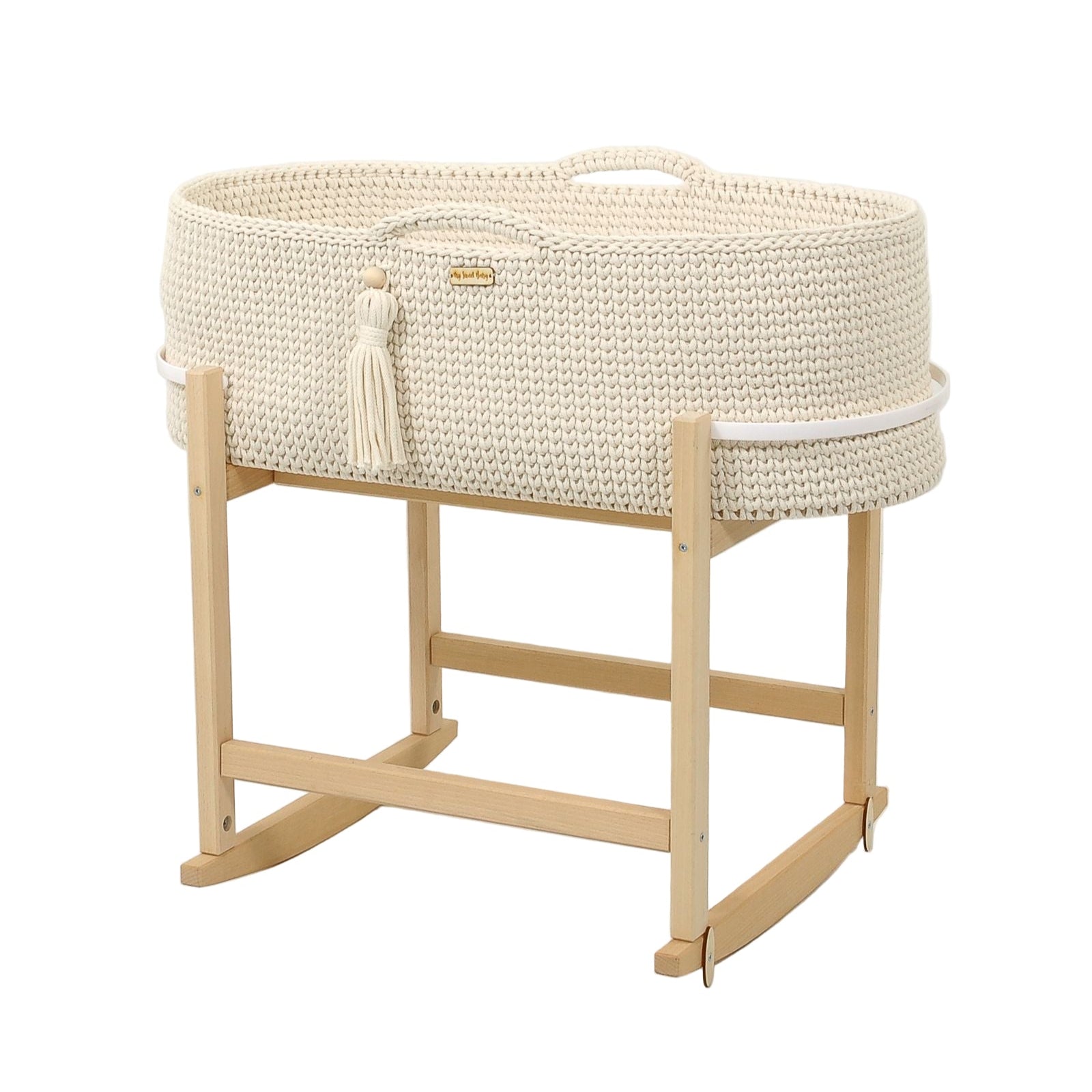 White woven baby crib with natural wood stand on a light gray background