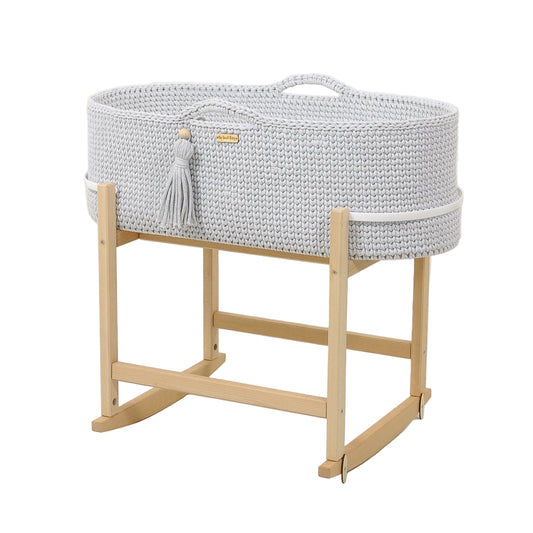 Gray woven bassinet with wooden stand on a white background